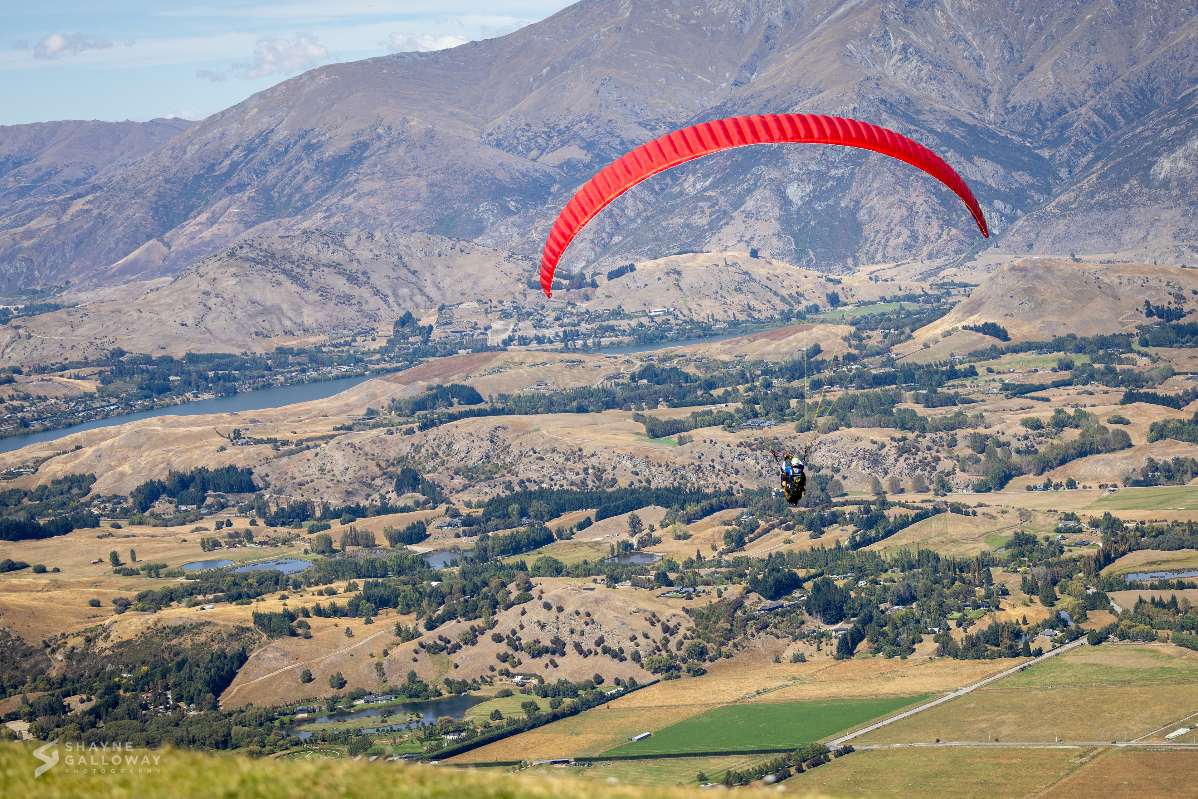 Paraglider soaring above the mountains