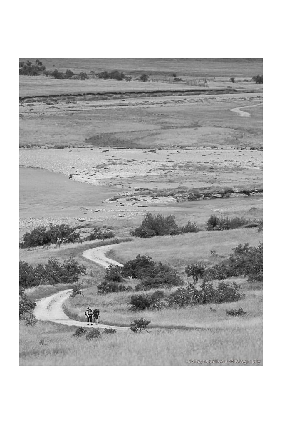 Walkers on a winding track through the Rees Valley